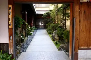 <p>Doorway from a busy city street to a quiet garden</p>