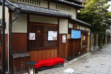 <p>Red felt covered bench outside a restaurant</p>