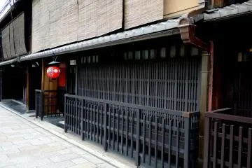 <p>Dark wooden lattice and a red lantern</p>