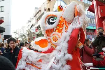 An acrobat prepares himself for the Lion Dance during the Chinese Lunar New Year festivities