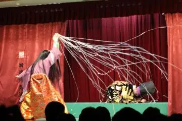 <p>He throws a net at the praying shogun</p>