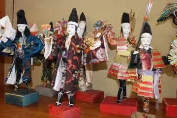 <p>Paper doll crafts on display</p>