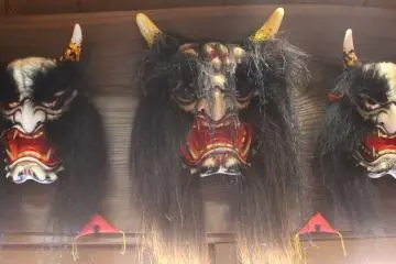 <p>Masks hung up above the doorway. The masks get larger as the play goes on</p>