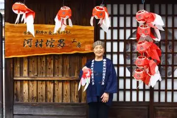 <p>Masae-san outside her shop</p>