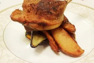 <p>Duck served over a bed of fried potatoes and roasted vegetables</p>