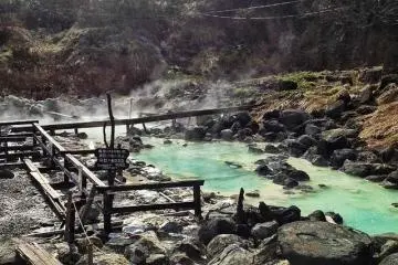 <p>This sulphurous pool bubbles in the grounds of Kuroyu, but don't touch the water - it's scalding hot! Water is piped from the source to the different pools, cooling down to a bearable temperature along the way.</p>