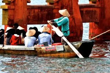 <p>Boats for hire bring visitors and pilgrims all the way up to the torii gate</p>