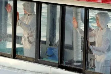 <p>Waving goodbye to the watching tourists</p>