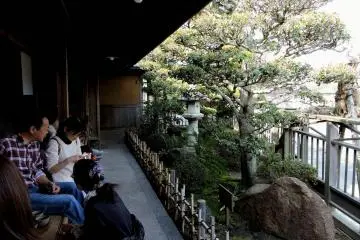 <p>A narrow veranda behind the store overlooks a small Japanese garden</p>