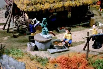 <p>A girl washes persimmons under a water pump in this model</p>