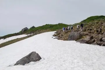 There is still snow on top of Mount Gassan in mid summer. 