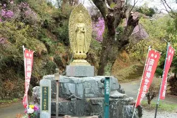 <p>A golden Kannon, or Goddess of Mercy, looks out over the garden.</p>