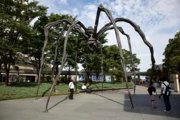 Modern art pieces are scattered around the grounds
