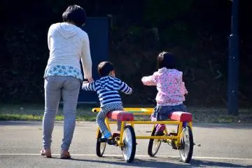 <p>A mother and children playing with a 'fun bicycle (Omoshiro Jitensha)'</p>