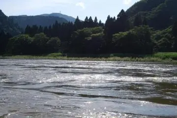 Riding the rapid currents of Mogami River in a small boat could be dangerous.