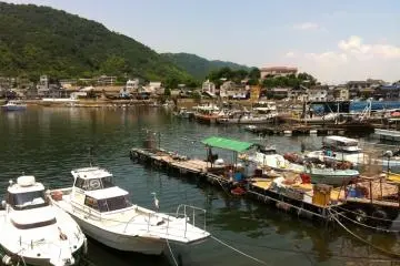 Boats docked on the landing at Tomo-no-ura Bay