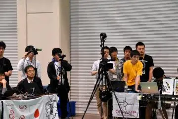 <p>Serious spectators and photographers watching the game</p>