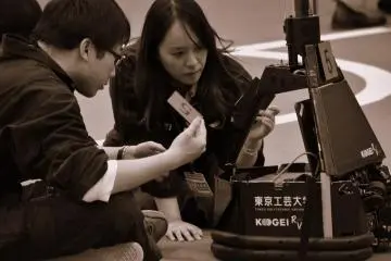 <p>Serious faces of technicians from Tokyo Polytechnic University checking up their robots</p>