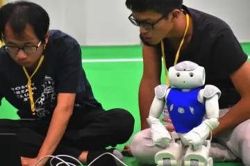 <p>Taiwan team members tuning their humanoid with serious faces, while the humanoid is waiting with an innocent expression.</p>