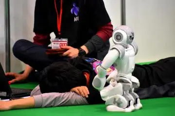 <p>A team member lying down on a floor taking rest. Programming humanoids must be exhausting.</p>
