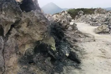 <p>Steam from deep inside the earth chars nearby rocks</p>