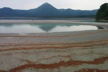 <p>A pond with Lake Usori in the background</p>