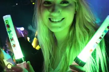 <p>Glow sticks are passed out to the audience members</p>