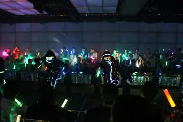 <p>As it goes dark the dancer costumers and glow sticks from the audience really stand out</p>