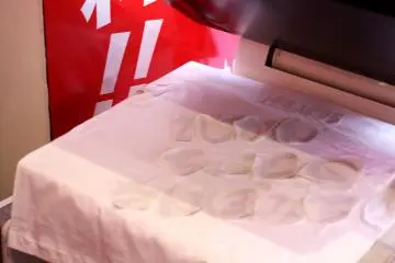 <p>The characters are printed out and put upside down on the T-shirt before the top of the heat press machine comes down to heat and meld everything together.&nbsp;</p>