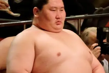 <p>Sumo wrestler Ichinojo watches the ring</p>