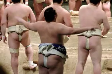 <p>Is this sumo wrestler stretching or praying? &nbsp;</p>