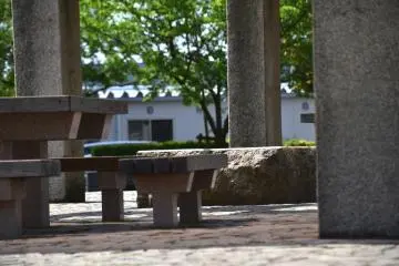 <p>A pavilion with tables and benches providing shade inside the park</p>