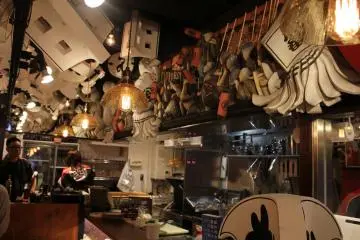 Above the counter seating on the first floor, several decorations from old firehouses