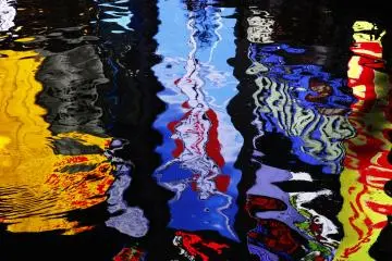 <p>Neon lights reflect in the river.</p>