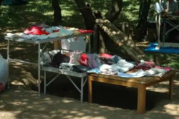 <p>Sometimes, there are children's clothes given for free. In the background is a slide made from forest materials.&nbsp;</p>