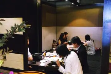 <p>A peak into the back of the restaurant which offers private rooms and several low communal tables</p>