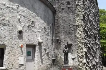 This statue has a little yard all to herself