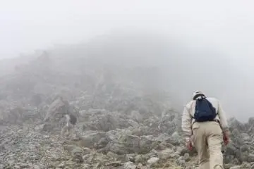 <p>Hikers have to scramble over loose scree for the last part of the climb</p>