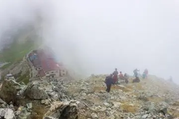 <p>Hikers pause for a rest after the difficult climb up the loose rocks
&nbsp;</p>