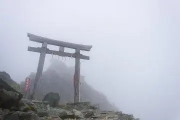 <p>The priest get barely be seen on the summit under the heavy cloud cover</p>