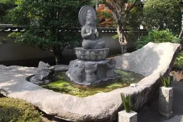 <p>The Kannon sits on her water-lily, making sure you purify your hands before you go on</p>