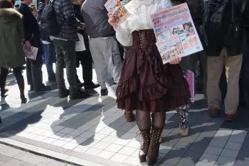 <p>Cute Vitorian style girl giving away pamphlets</p>