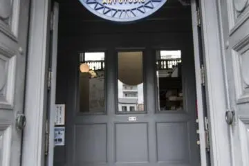 <p>The entrance into the Karakoro Art Studio. Note the dark boding entryway that leads to doors on eithers sides, this was how the building was constructed when it was the Bank of Japan.</p>