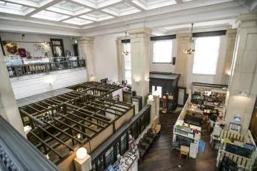<p>The view from the second floor. While the architecture of the Bank is clearly distinct, the new tenants and their interesting shops make for a bizzare but very curious constrast with the existing infrastructure.</p>