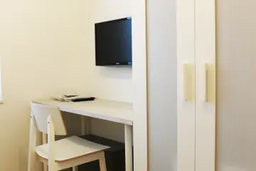 The rooms have a wardrobe, a desk, and a television.