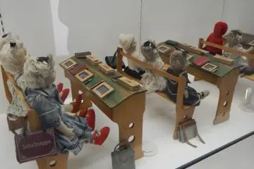 <p>A classroom of dolls "studying" their lessons</p>