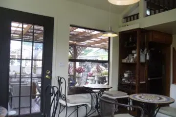 <p>Lovely and bright, but with air conditioning! You can see the outdoor seating area through the window.</p>