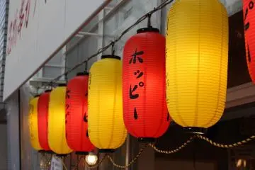 <p>Distinctive red and yellow lanterns that welcome you to Kushikatsu Tanaka</p>
