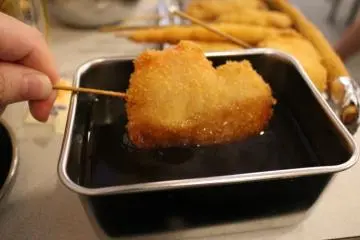 <p>Dipping in Tanaka's original sauce</p>
