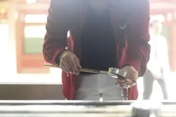 <p>A man washes his hands before entering.</p>